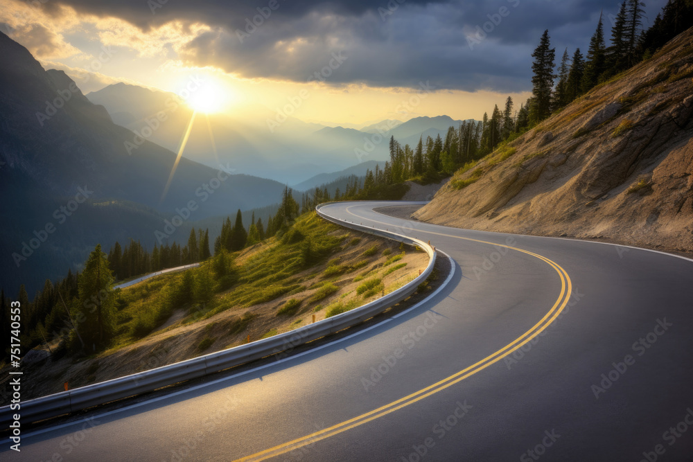 Winding asphalt road cuts through the mountain, with the sun shining through the clouds. High quality photo
