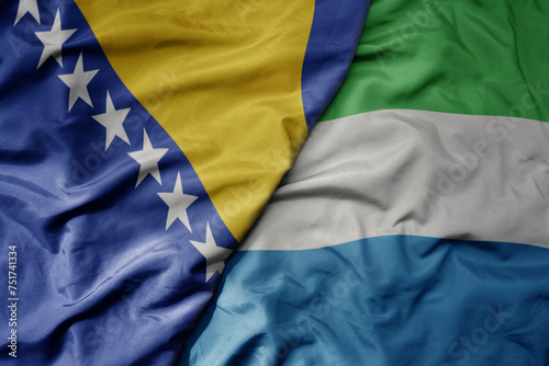 big waving national colorful flag of sierra leone and national flag of bosnia and herzegovina.