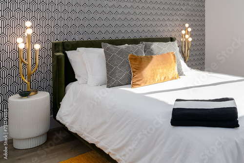 Black and white bedroom with gold accents and wallpaper