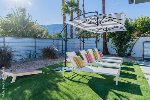Принти на полотні Backyard lounge chairs outdoors with umbrellas