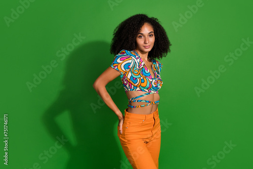 Portrait of nice gorgeous woman chevelure hairstyle posing seems confident in her new bershka outfit isolated on green color background photo