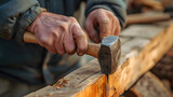 carpenter hitting wood with hammer