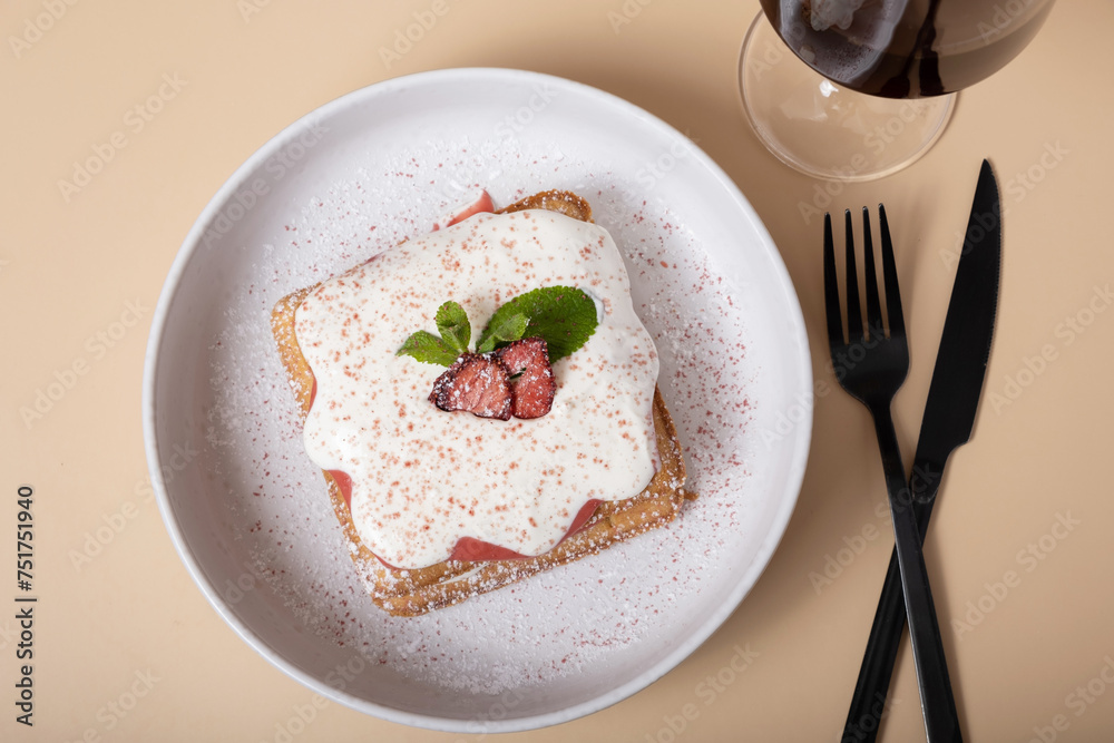 Belgian waffles with strawberry confit and cream sauce on beige background top view Belgian waffles with strawberry confit and cream sauce on beige background top view
