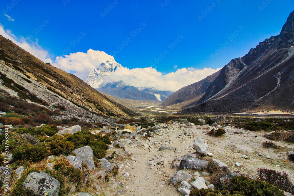 Scenic panorama of the Everest base camp trail looking south along the Khumbu valley towards the village of Dugh La and Periche with Ama Dablam dominating the horizon in Nepal