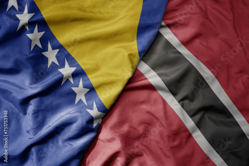 big waving national colorful flag of trinidad and tobago and national flag of bosnia and herzegovina.
