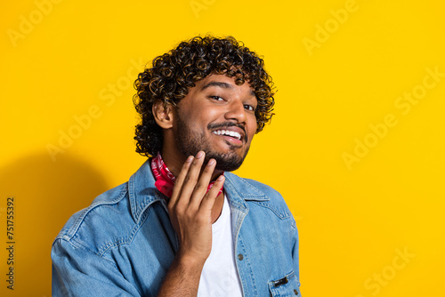 Photo portrait of handsome young guy touch chin barbershop promo dressed stylish jeans garment red scarf isolated on yellow color background