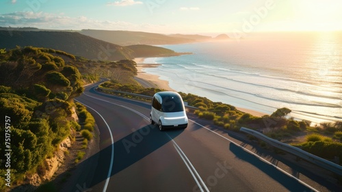 modern, eco-friendly autonomous pod travels along a scenic coastal road at sunset, showcasing the integration of advanced transportation with natural beauty photo