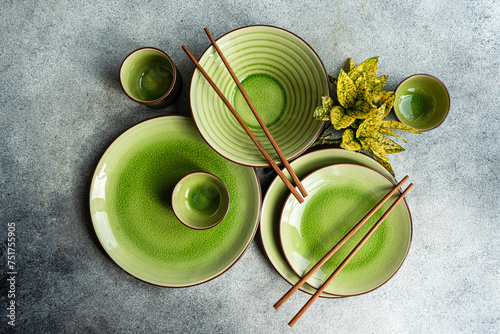 Elegant green ceramic tableware with chopsticks from above photo