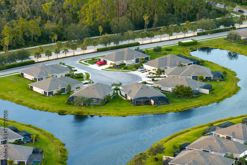 American dream homes on rural cul-de-sac street in US suburbs. View from above of waterfront residential houses in living area in North Port, Florida