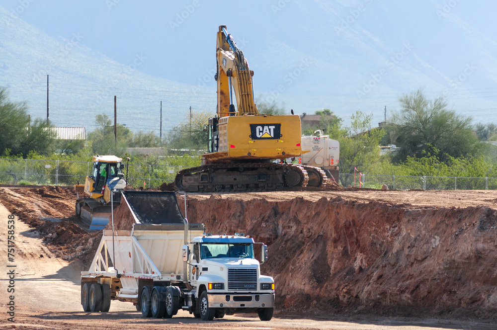 A dump side truck equipped with a side dump trailer for dirt removal ...