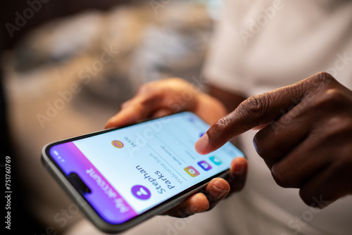Close-up of a man using a smartphone with bank app