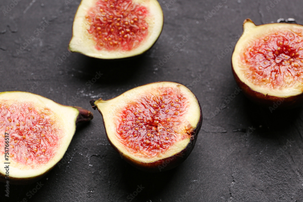 Halves of fresh ripe figs on black background Halves of fresh ripe figs on black background