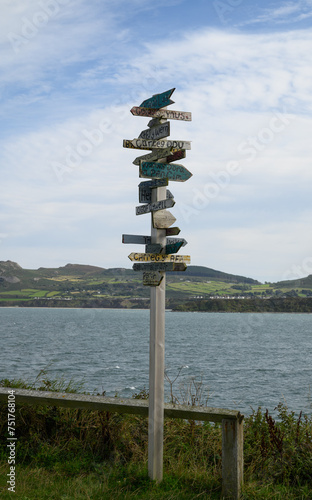 Signpost with multiple locations on the Porthdinllaen coastal path in Wales