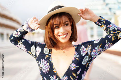 Gorgeous young woman smiling broadly with healthy white teeth, wearing summer hat. Happy female.