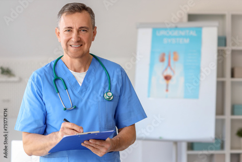 Mature doctor with clipboar...