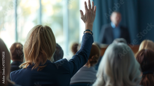 active participation at a conference or seminar, where attendees are raising their hands, likely to ask questions or vote on a discussion point.