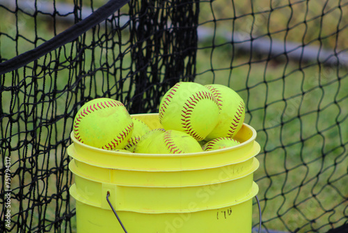 A 5 gallon bucket of used softballs © David McQ