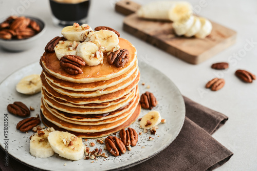 Plate of maple pecan pancakes with fresh bananas