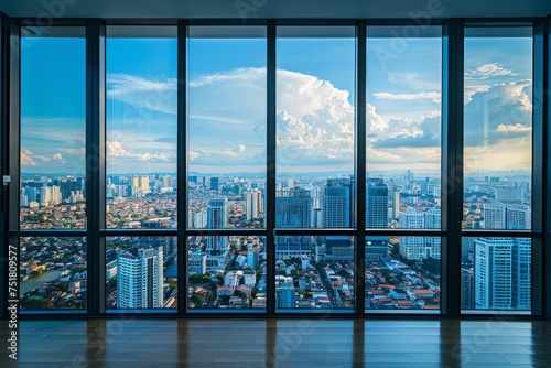 A spacious view showcasing the vast urban skyline beyond large floor-to-ceiling windows