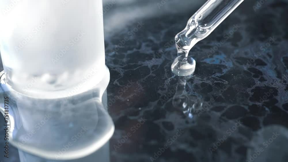 A woman serving beauty essence from a pipette bottle on a table with an image of the sea A woman serving beauty essence from a pipette bottle on a table with an image of the sea