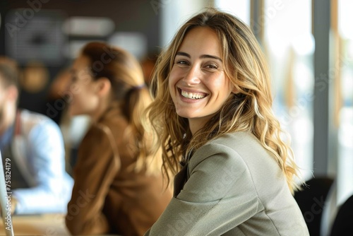 Wallpaper Mural Confident young professional smiling at the camera with colleagues in the background in a modern office Torontodigital.ca