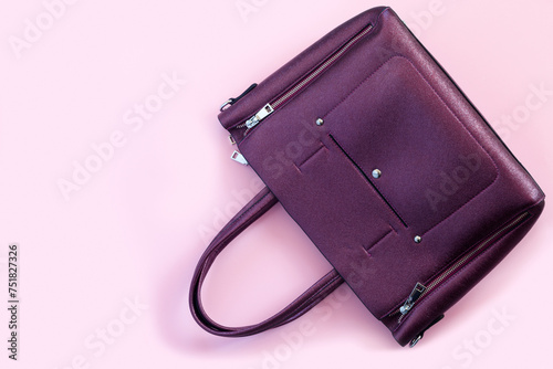 Beautiful leather purple handbags on pink paper background  in zine style.