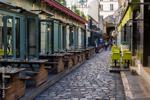 Cozy street near Boulevard San-German with tables of cafe  in Paris, France. Cityscape of Paris. Architecture and landmarks of Paris