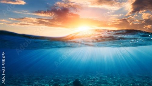 blue sea or ocean water surface and underwater against sunset photo