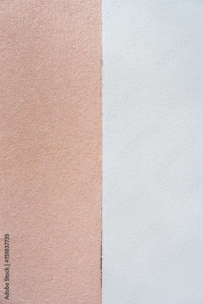 Fototapeta premium Fascinating position of two distinct wall textures and colors. Left side rough, brown texture while right side presenting smooth, white surface. Clear straight line separating them