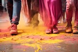 Colorful holi powder splashing on feet of people during Holi festival