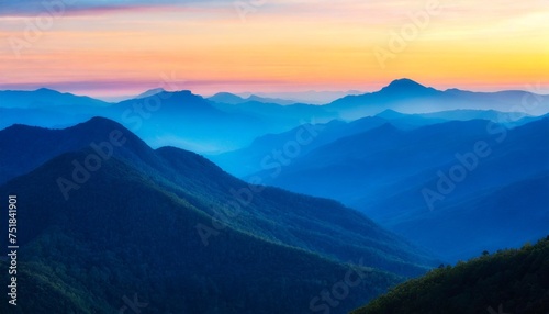 beautiful layered blue mountains transitioning into the sunset vetical photo