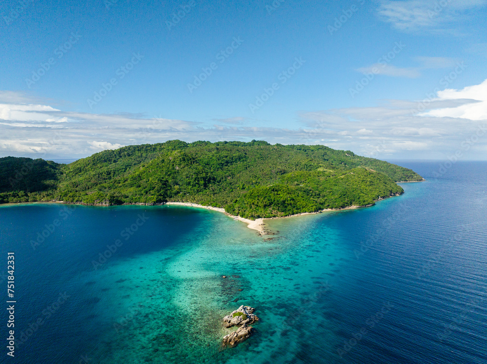 Top view of Blue sea and Alad Island with small white beach. Romblon, Philippines.