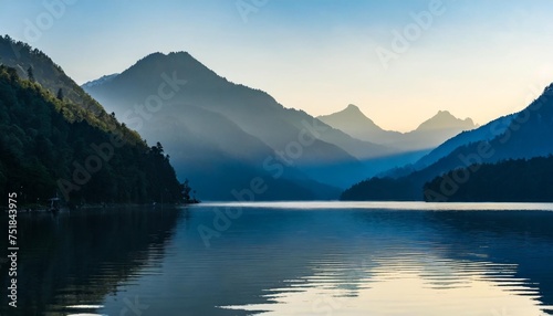 layers of mountains by the still lake in the morning
