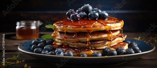 A delicious stack of American pancakes topped with sweet blueberries and drenched in golden honey syrup, served on a rustic wooden table.