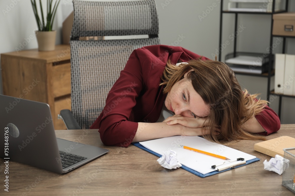 Sad businesswoman working at wooden table in office - obrazy, fototapety, plakaty 
