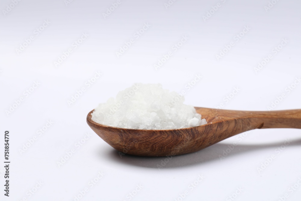 Natural salt in wooden spoon isolated on white