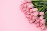Bouquet of beautiful tulips on pink background, above view. Space for text