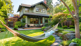 A suburban craftsman house in mint green, with a backyard oasis including a hammock and a rock garden.