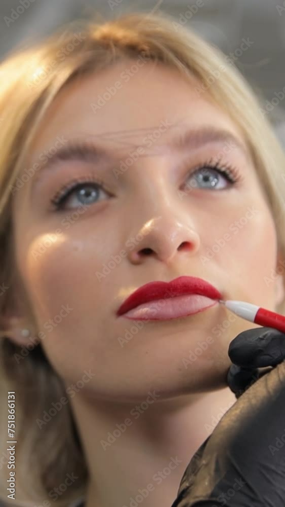 A woman enhancing her smile with permanent makeup on her lips A woman enhancing her smile with permanent makeup on her lips