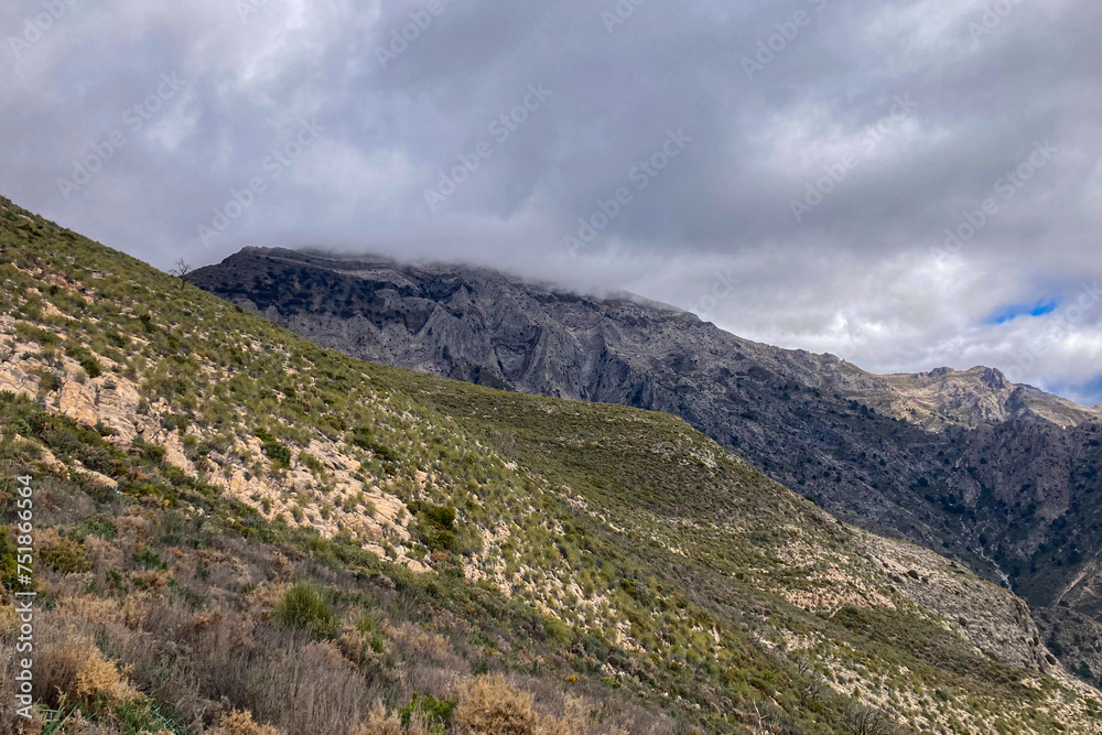 Panoramic view from hiking trail to Maroma peak in thunderstorm day, Sierra Tejeda, Spain 