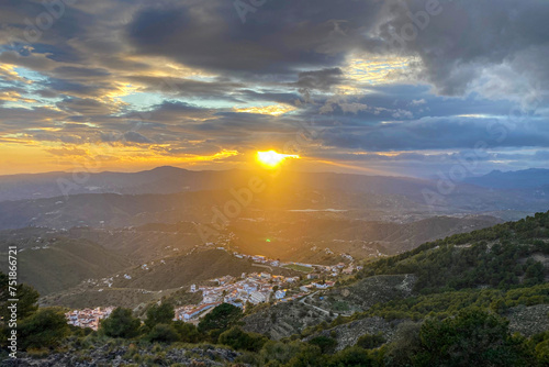Sunset over valley from hiking trail to Maroma peak in thunderstorm day, Sierra Tejeda, Spain 