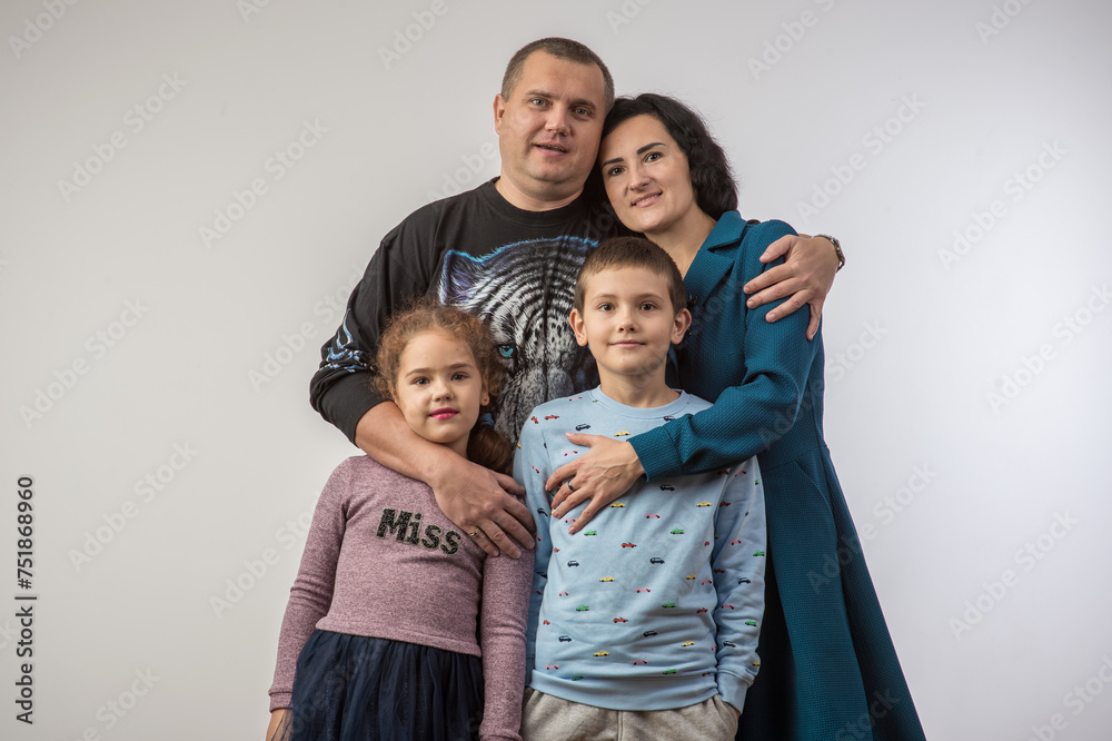 studio portrait of a happy family husband wife daughter and son 3