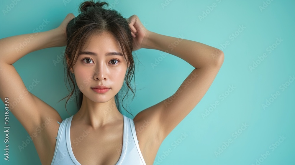Portrait of young Asian woman show her armpit isolated on light blue background. Portrait of young Asian woman show her armpit isolated on light blue background.