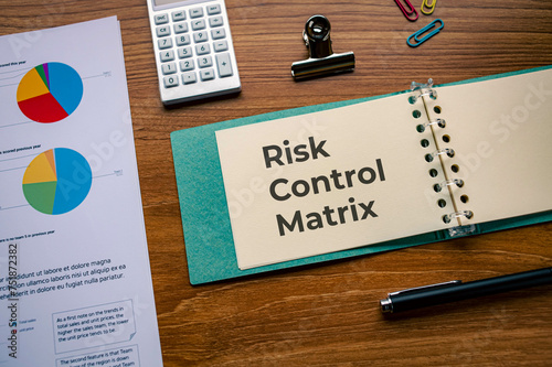 There is notebook with the word Risk Control Matrix. It is as an eye-catching image. photo