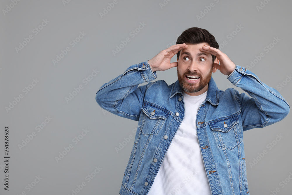 Portrait of surprised man on grey background, space for text Portrait of surprised man on grey background, space for text