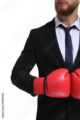 Businessman in suit wearing boxing gloves on white background, closeup © New Africa