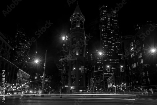  Night Toronto life - historical and contemporary downtown with streets ligtht. Black and white. Historic red bricks thin building at downtown Toronto.  photo