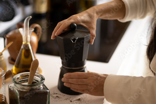 Woman making coffee in an italian coffee maker