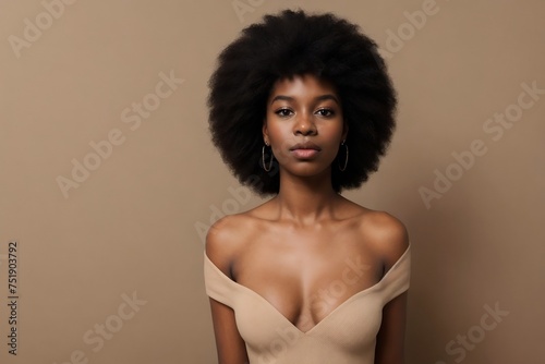 Beautiful young black afro woman looking at the camera on a beige background with copy space. Beautiful black woman with pretty skin. Skin Care Concept.