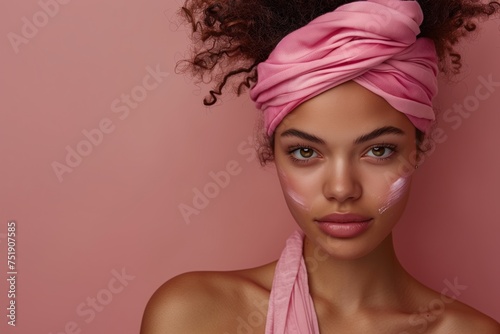 Beautiful young afro american woman with pink headband and clean fresh skin, on beige, pink background with copy space, facial skin care.  Cosmetology, beauty, spa.  female cosmetics concept.